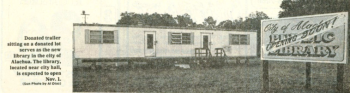 An image of the white old library trailer on the lot where the present building is located.