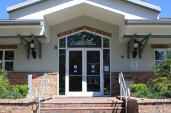 The front of the library is shown with stairs leading to the double doors