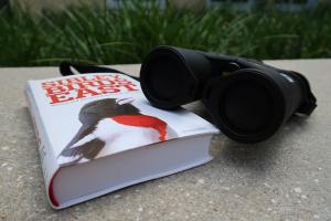 Binoculars and a book on birds