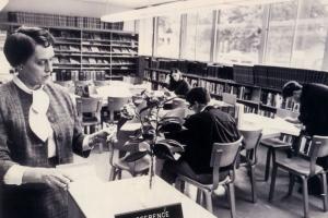 Woman looking at a catalog card in a historic library photo