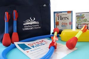 STEM Kit with rocket toys, bag, book, and a movie