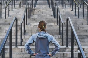 Woman facing stairs