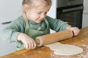 Child rolling out dough