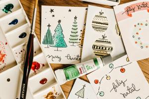 Painted holiday cards and a paint brush