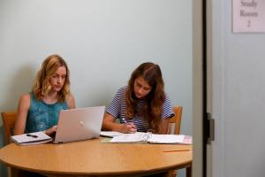 Two women studying at the library