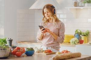 someone holding up and using a mobile device in front of them