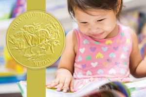 Caldecott Award overlayed on photo of child looking at an open book