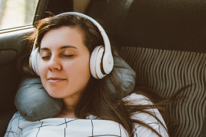 Woman listening to headphones in a car
