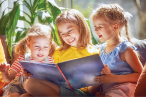 Children reading and smiling