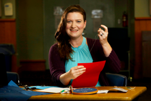 Smiling woman sewing. 
