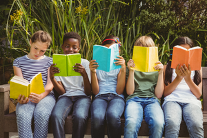 Five kids reading books with different color covers