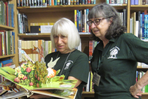 Friends of the Library volunteers opening a 3D book