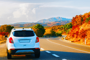 Car driving through mountains during Fall