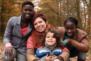 a group of people posing for a picture together as a family