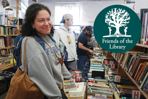 people looking at books at the Friends of the Library Book Sale with a Friends of the Library logo of a tree on an open book with someone standing on either side