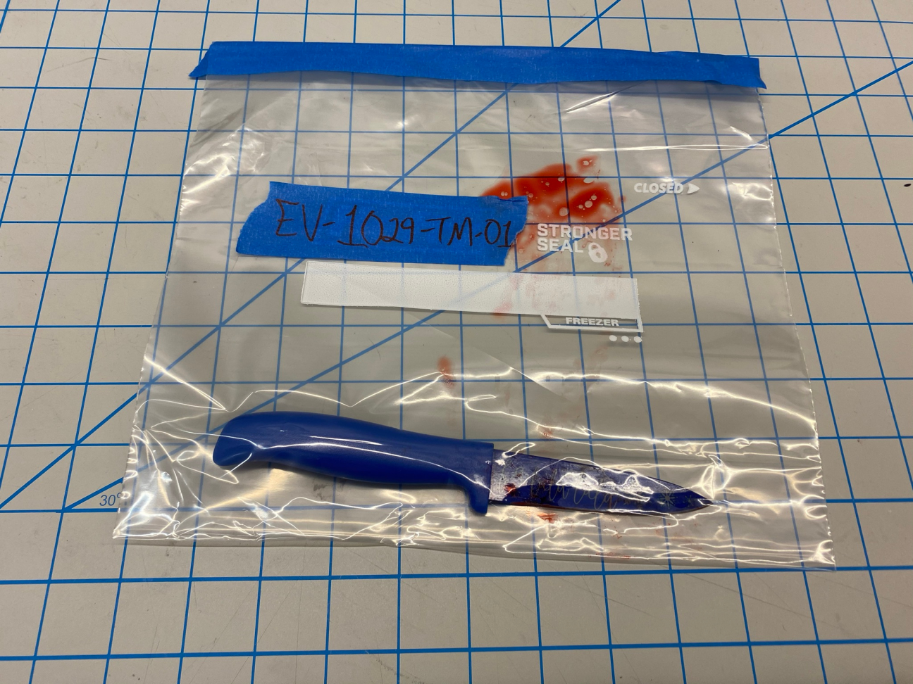 Evidence: Murder Weapon Photo of an evidence bag, which contains the knife used to kill the victim. The knife is blue and has "falalalala" written on the blade.