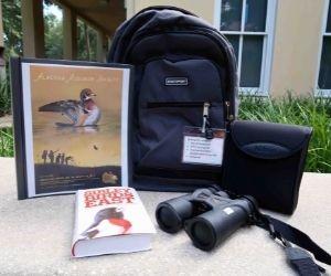 Birding books, binoculars, and a backpack