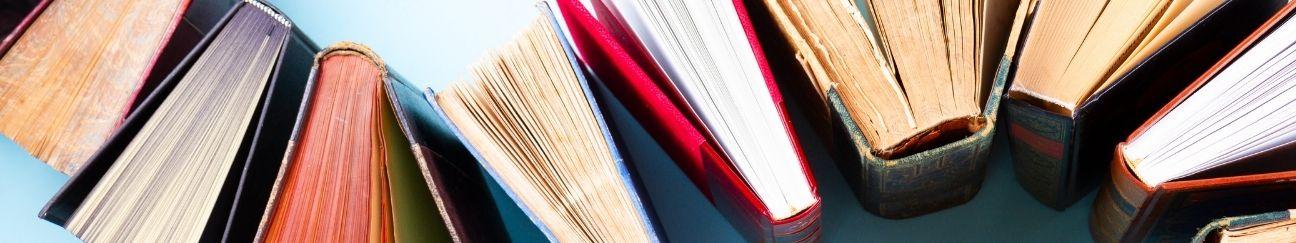 The spines of several books on a blue background