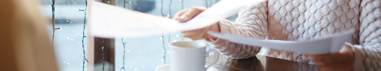 header of woman holding papers