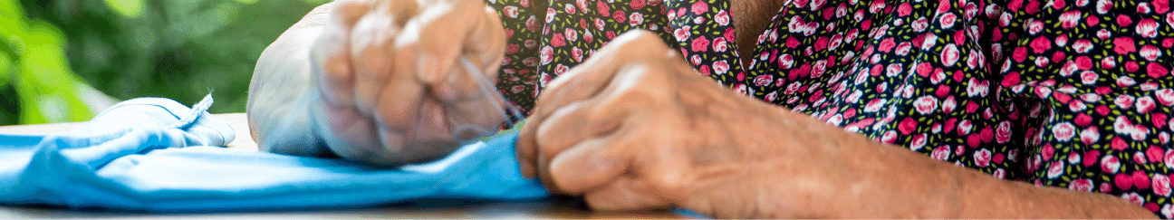 header of hands sewing a garment