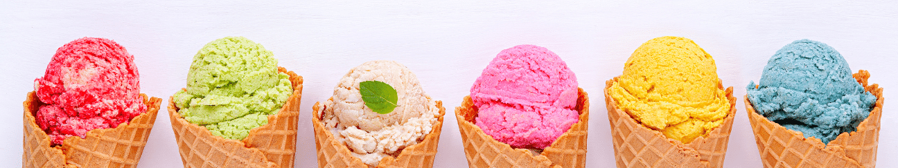 row of ice cream cones with a rainbow of different colored ice cream scoops