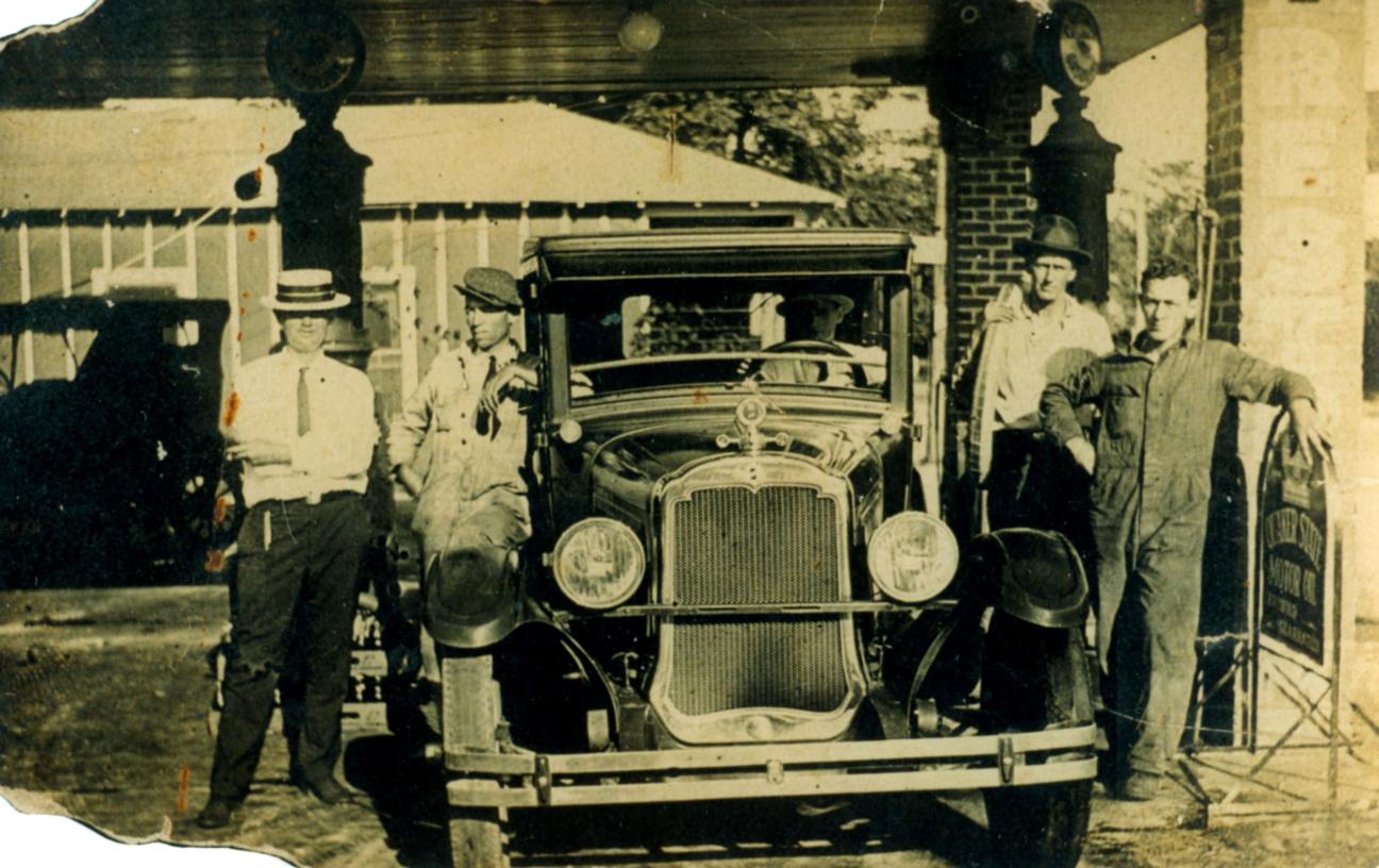 Men surrounding car at Collins Service Station in High Springs
