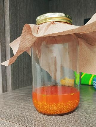 Jar quarter filled with tomato seeds