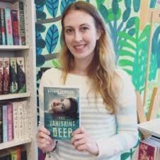 Author Astrid Scholte holding a copy of The Vanishing Deep