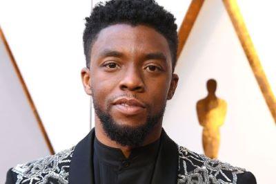 picture of African American male dressed in black and gold suit