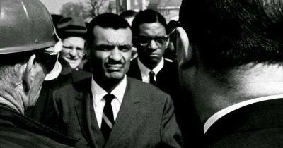 African american male dressed in a black and white suit and tie