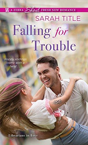 The cover of "Falling for Trouble", a novel by Sarah Title, which features a couple (both white, the man has brown hair and the woman is blond with pink streaks in it) hugging and laughing. The background is a blurred library shelf.