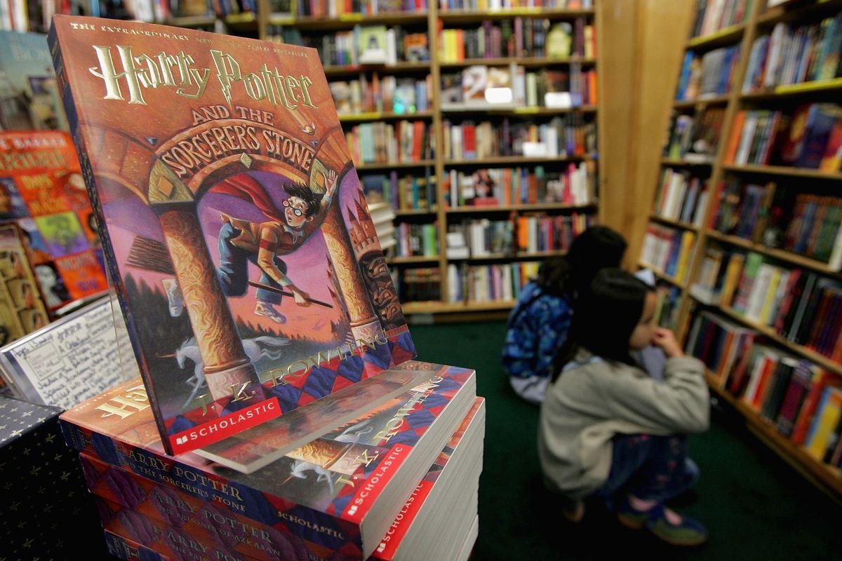 harry potter book on display with bookshelves blurred in the background