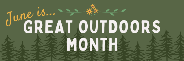 The words "June is..." in yellow on a dark green background, sitting atop the words "Great Outdoors Month" in white. There are small yellow flowers above the words and forest green pine trees behind them.
