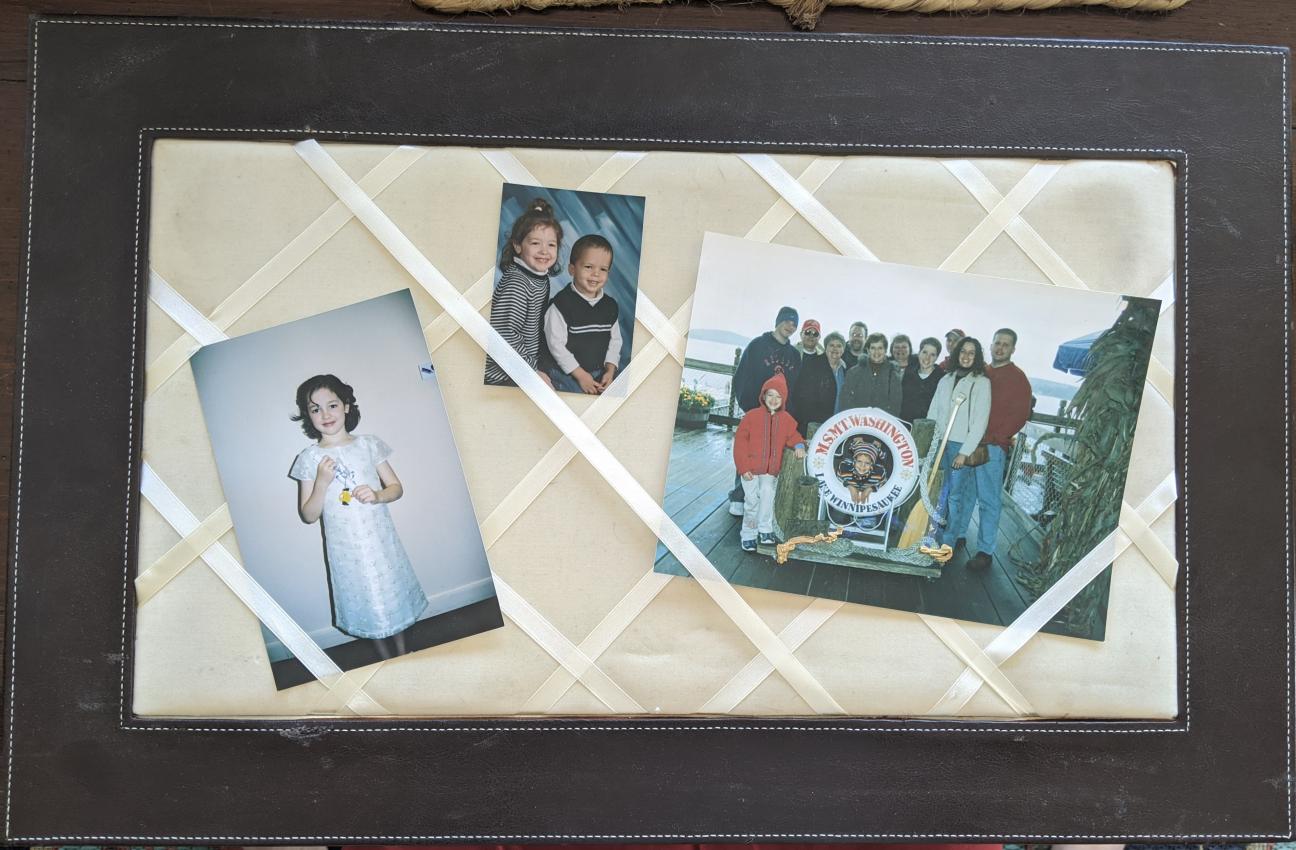 A photo board with three photos woven under the criss-crossed ribbons.