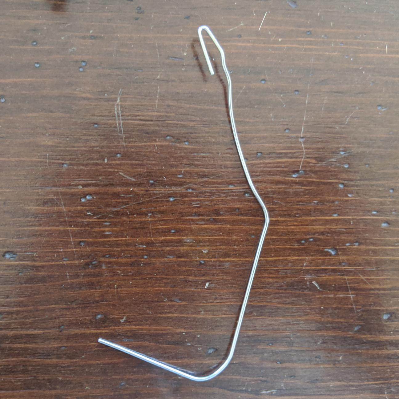 A unbent paperclip, with one end bent to form a small hook.
