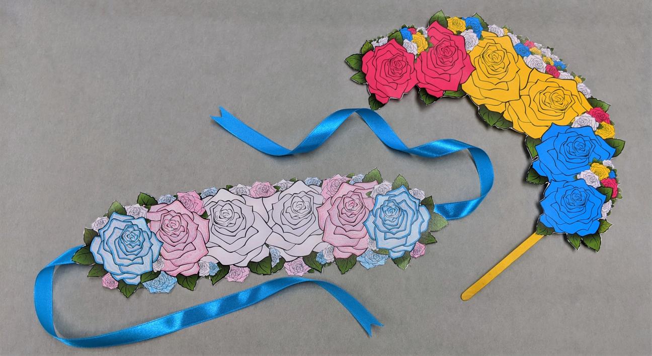 Final accessorized flower crowns A photo of the same two flower crowns, now backed with cardboard and with ribbon attached.