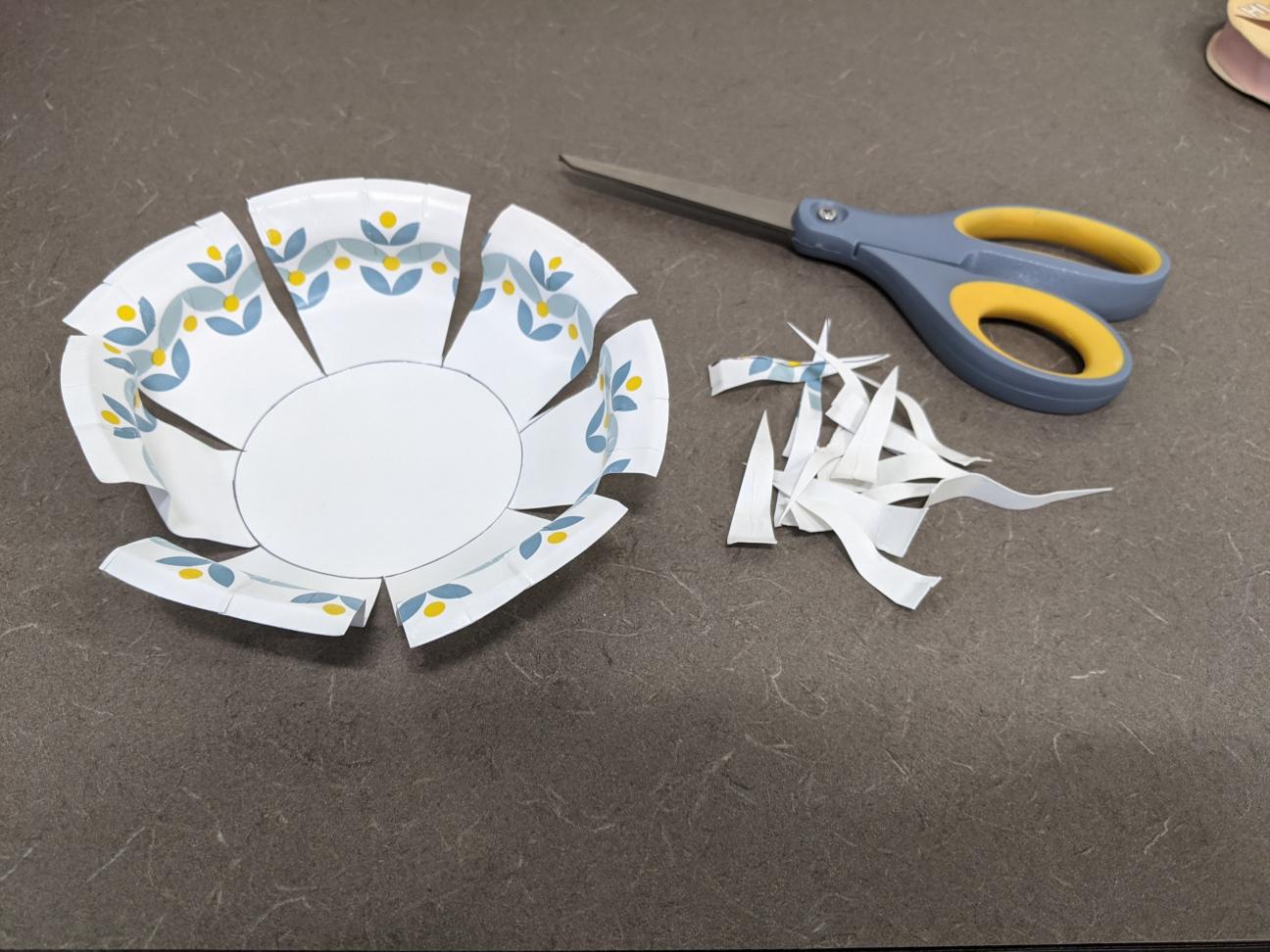 Cut out your V-shape The same paper plate, now cut along the lines with more cut out to form a V-shape between each side.