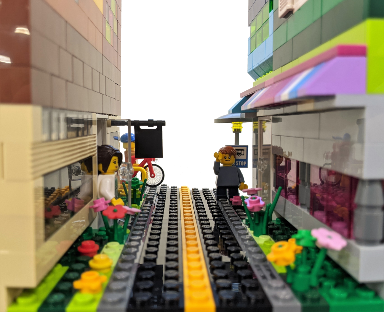 Make a LEGO book nook of your own! A close up photo of a LEGO book nook, showing a scene of a street with tall buildings on either side