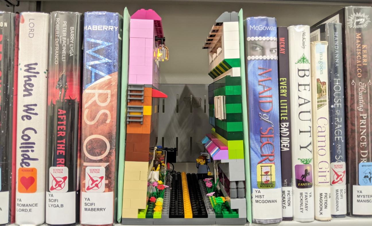 A photo of a LEGO book nook on a bookshelf.