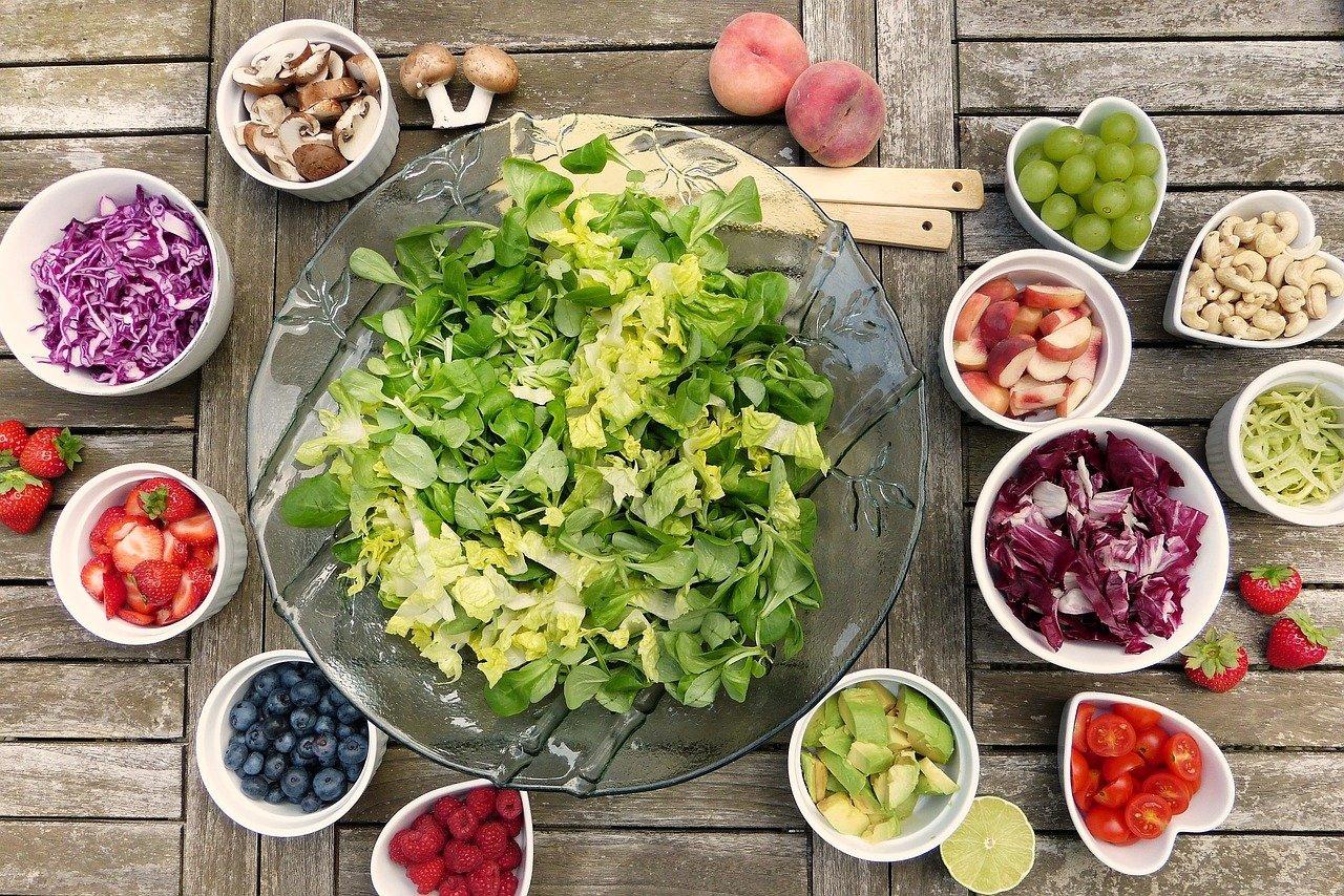 Salad Ingredients A top down view of a selection of fruits and vegetables in circle and heart shaped containers.