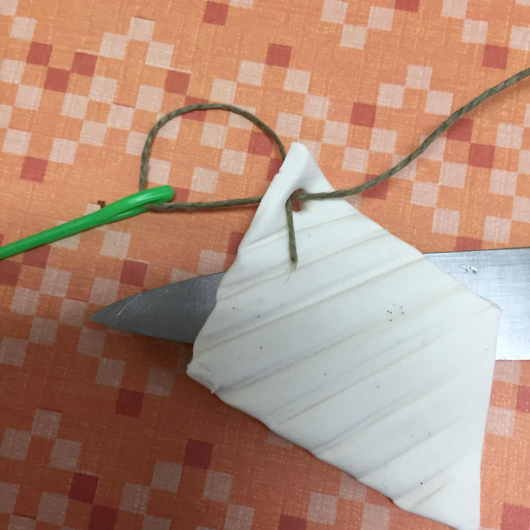 Needle pulling cord through clay diffuser Needle pulling cord through clay diffuser