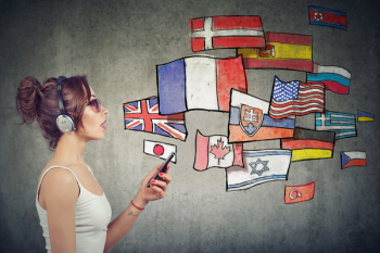 A photo of a person holding a phone and wearing headphones. Sketches of various national flags are leaving their mouth. 