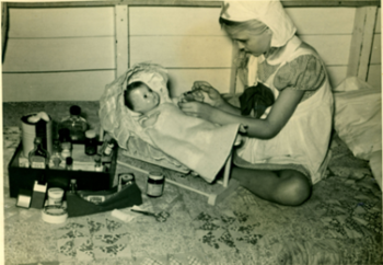 Mary Godwin giving first aid to doll