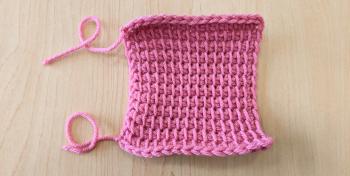 A photo of a pink crochet swatch, done in Tunisian Simple Stitch. The final measurements are 16 stitches by 12 rows.