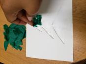 Applying colored tissue paper pieces to card.