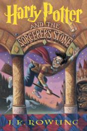 A boy on a broom flies between two pillars in the countryside witha castle in the background