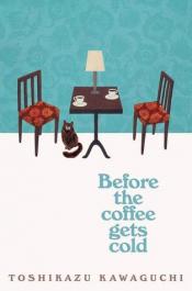 Two chairs on a blue background with a table set with coffee and a table. On the ground there is a cat.