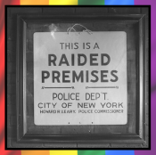 A framed historic sign stating "This is a RAIDED PREMISES - Police Dept City of New York". 