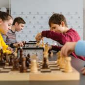 teens in chess club playing matches