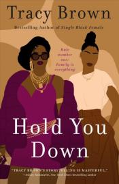 Book Cover. Hold You Down in white text. Simple graphic style pair of women, one wearing a short purple dress and the other wearing a white shirt and long brown skirt, on a brown and tan background.